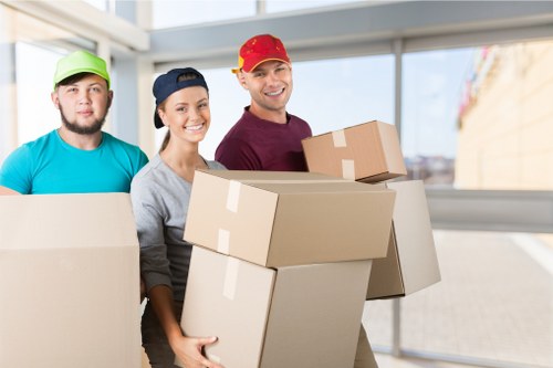 Removal team handling furniture and boxes in a Chalkfarm property