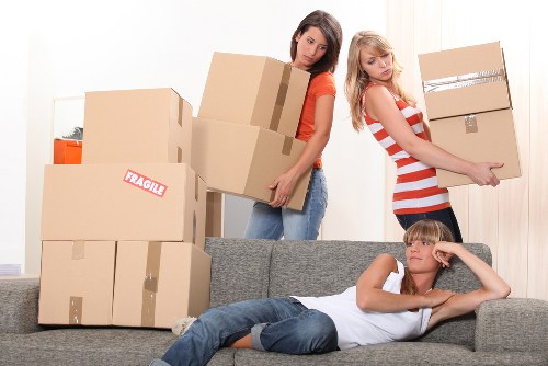Professional movers handling furniture in a Chalkfarm home